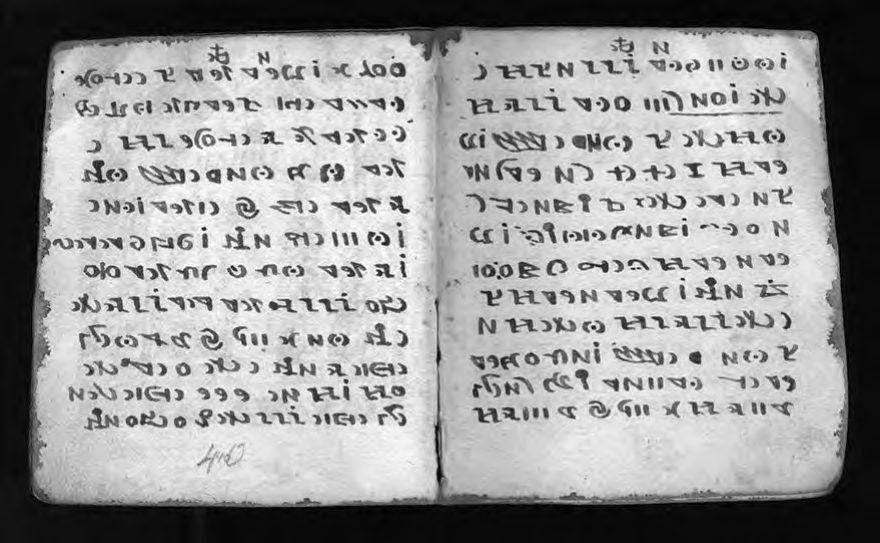 A two-page spread of the Rohonc Codex showing dense rows of symbols across both
      leaves with no illustration.